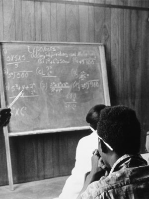 A volunteer mathematics teacher with students at Tufts, Mound Bayou, Mississippi (1968), Doris Derby.