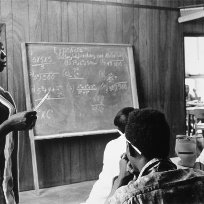 A volunteer mathematics teacher with students at Tufts, Mound Bayou, Mississippi (1968), Doris Derby.