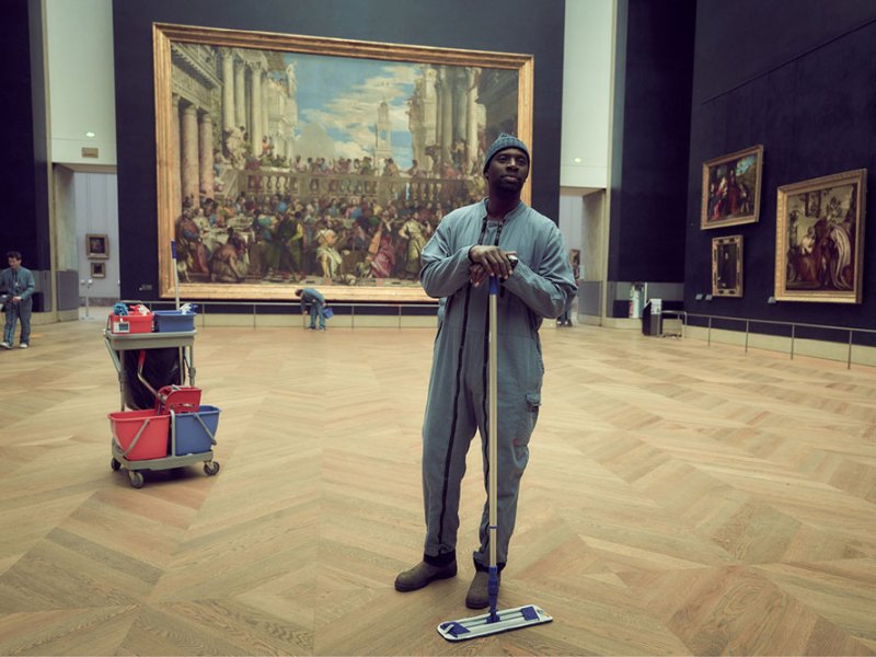 Omar Sy as Assane Diop in 'Lupin', with Veronese's 'Wedding Feast at Cana' in the background.