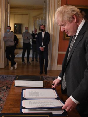 No more red tape? Boris Johnson signs the Brexit deal in December 2020.