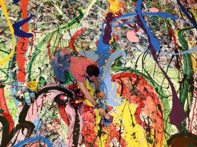 Art attack: Sacha Jafri painting his record- (and potentially back-) breaking artwork.