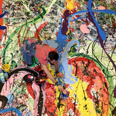 Art attack: Sacha Jafri painting his record- (and potentially back-) breaking artwork.