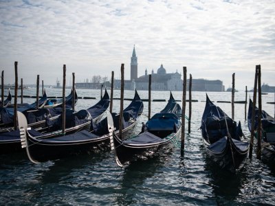 In hibernation: covered gondolas line the shore in Venice in December 2020.