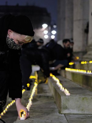 Carla Ecola, director of the Outside Project, lays memorial candles in Trafalgar Square as part of the Museum of Homelessness’s ‘Dying Homeless’ project (Photo: Anthony Luvera)
