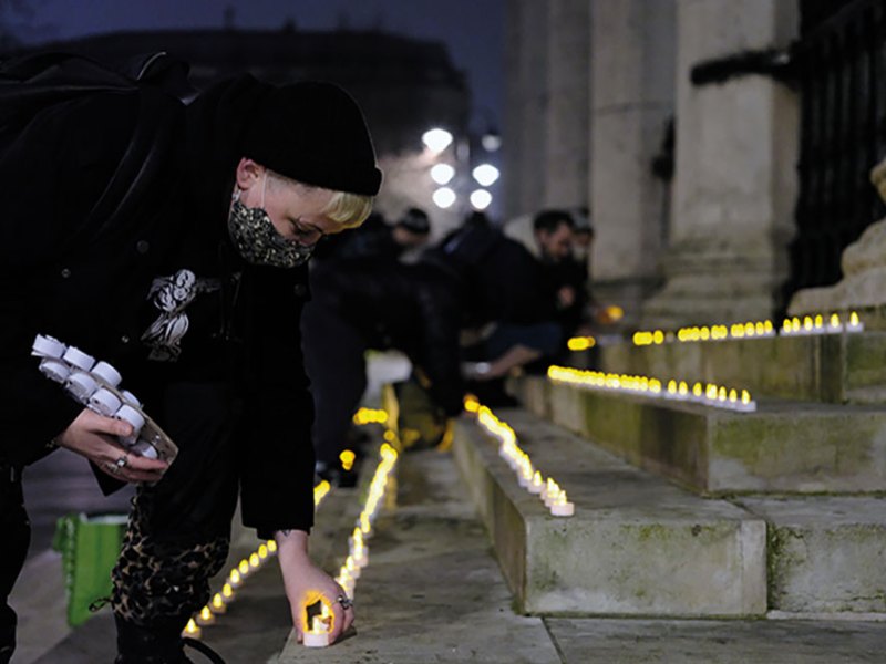 Carla Ecola, director of the Outside Project, lays memorial candles in Trafalgar Square as part of the Museum of Homelessness’s ‘Dying Homeless’ project (Photo: Anthony Luvera)