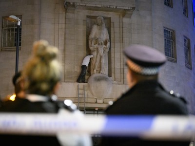 Up to the Gill – an activist with a hammer scales the BBC’s Broadcasting House. Photo: Leon Neal/Getty Images