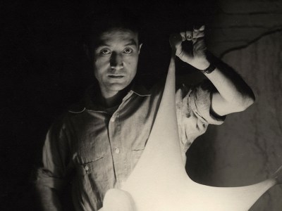 Isamu Noguchi with study for Luminous Plastic Sculpture, 1943