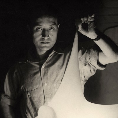 Isamu Noguchi with study for Luminous Plastic Sculpture, 1943
