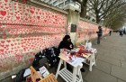 Clara Collingwood from Covid-19 Bereaved Families for Justice and Oliver Knowles of Led By Donkeys at the welcome desk of the Covid memorial wall on the Albert Embankment, London, in April 2021.