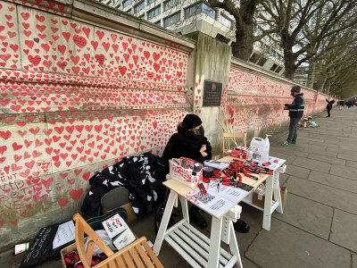 Clara Collingwood from Covid-19 Bereaved Families for Justice and Oliver Knowles of Led By Donkeys at the welcome desk of the Covid memorial wall on the Albert Embankment, London, in April 2021.