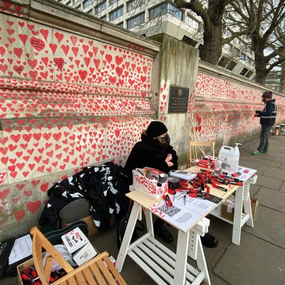 Clara Collingwood from Covid-19 Bereaved Families for Justice and Oliver Knowles of Led By Donkeys at the welcome desk of the Covid memorial wall on the Albert Embankment, London, in April 2021.
