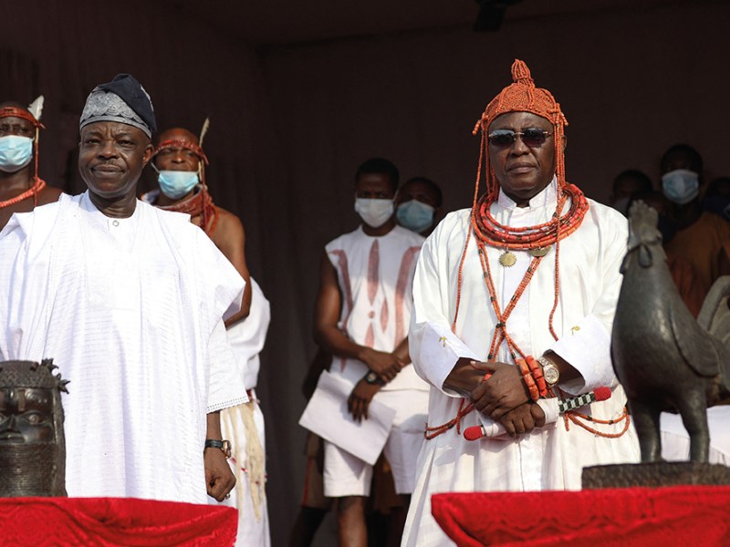 Oba Ewuare II (right), receiving restituted Benin Bronzes from Aberdeen and Cambridge universities in a ceremony in February 2022.