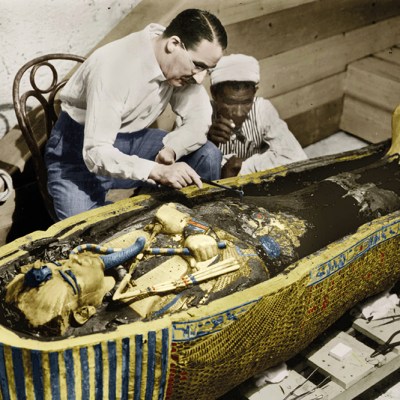 Howard Carter photographed with the golden sarcophagus of Tutankhamun in 1922 by Harry Burton (colourised version).
