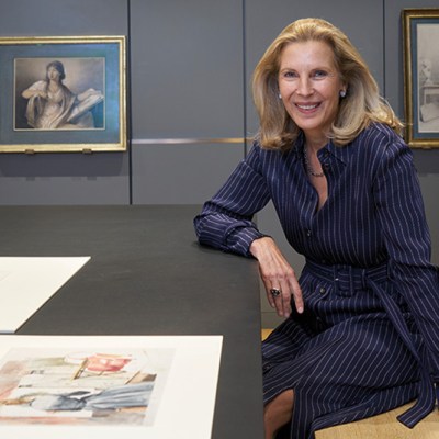 Katrin Bellinger photographed in her print room in London in May 2022. Behind her are drawings by Anne Guéret and Gjisbertus Johannus van den Berg.