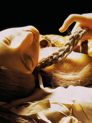wax figurine of a girl lying down