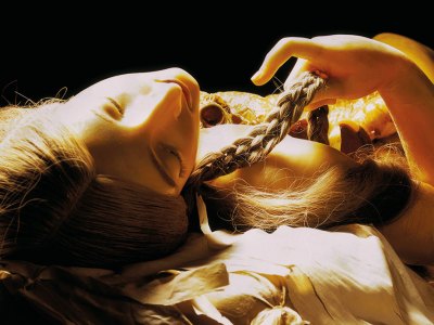 wax figurine of a girl lying down