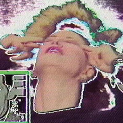 film still of glitching screen with a woman pressing her fingers to her temples