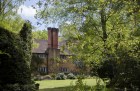 The view of Munstead Wood house across the west lawn.